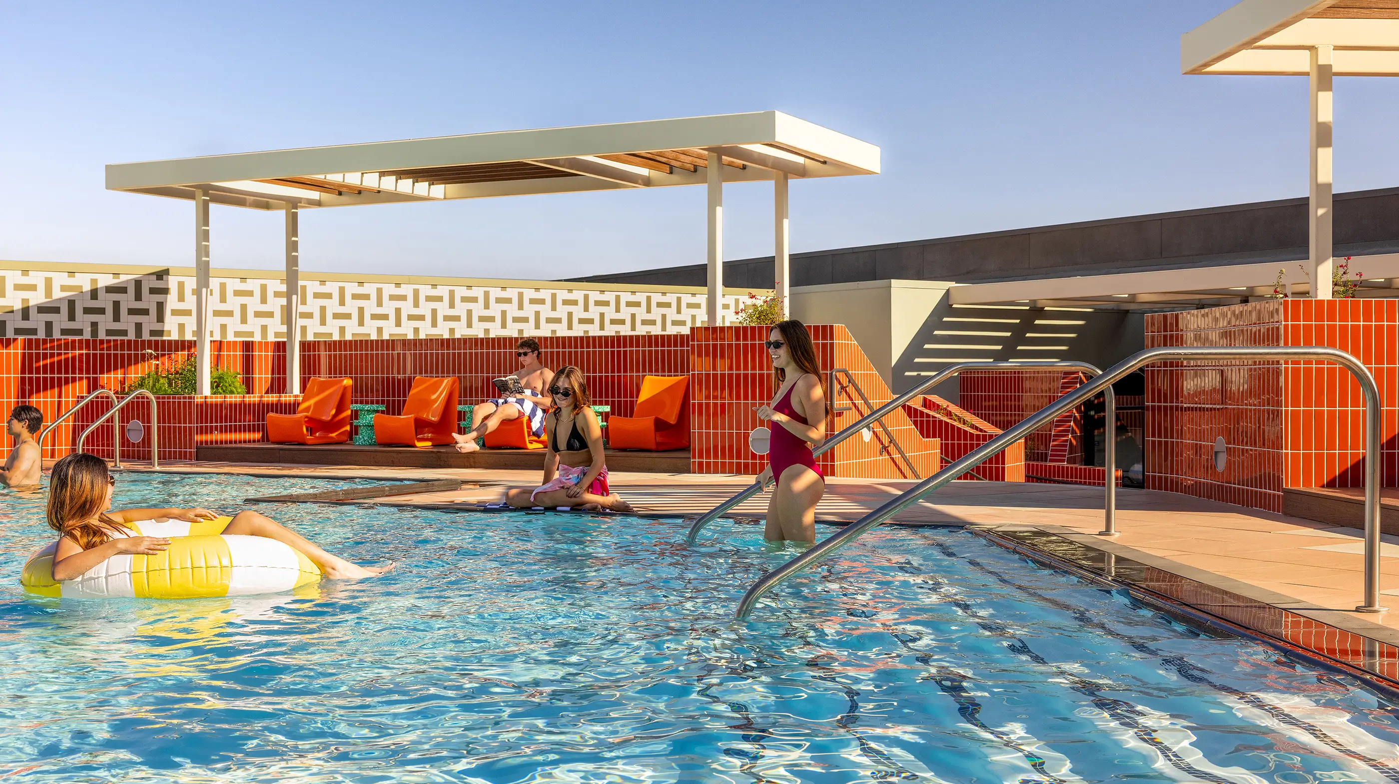 residents relaxing by a swimming pool