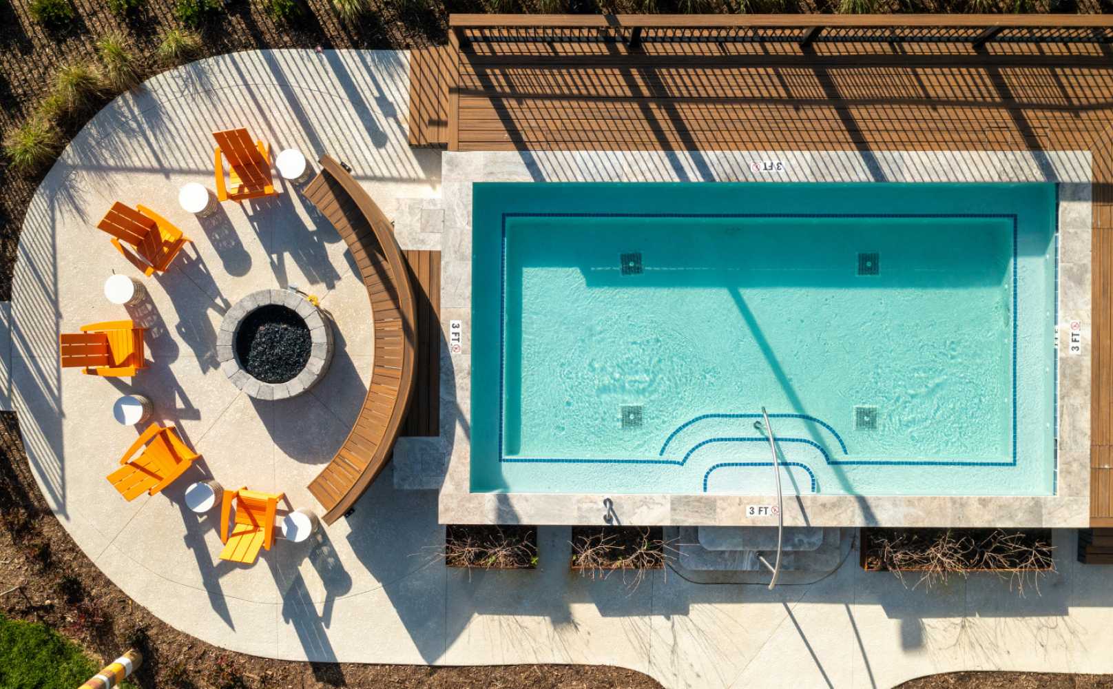 Aerial view of a swimming pool and firepit