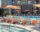 Orange umbrellas and chairs near a pool