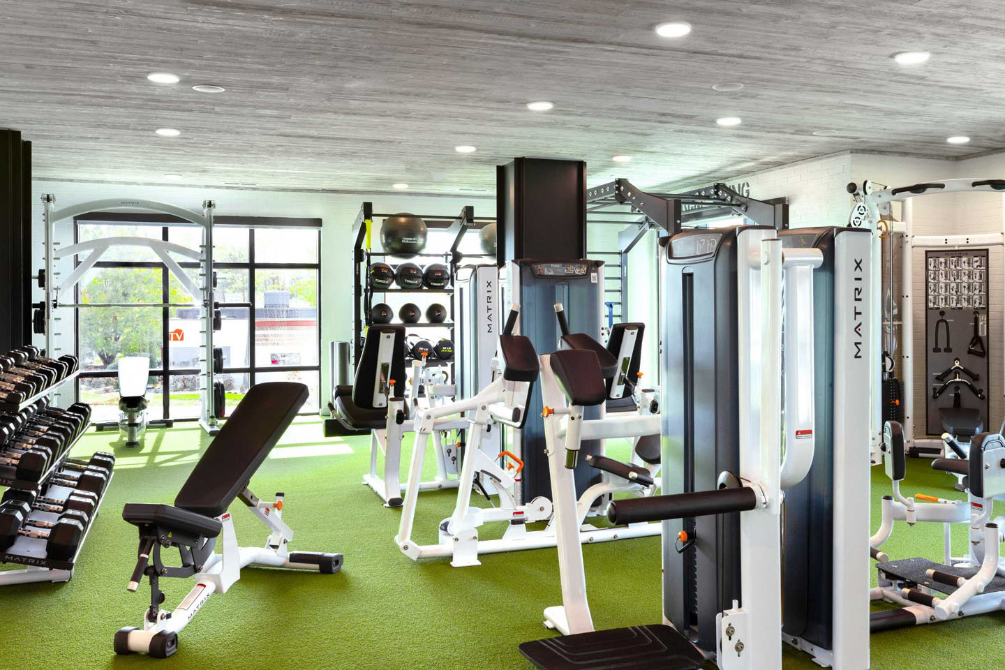 gym with equipment and benches