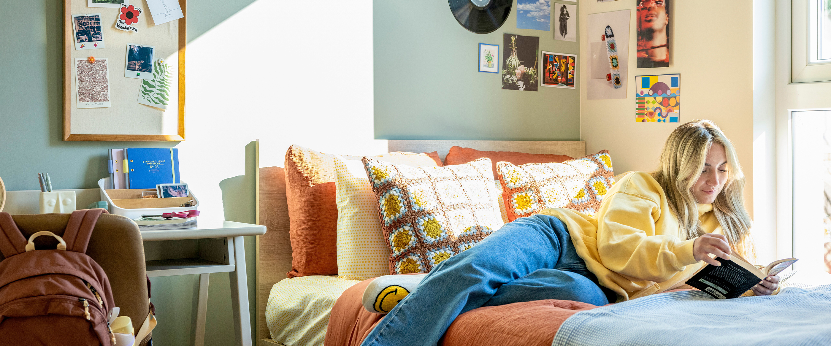 a woman reading a book in her bedroom
