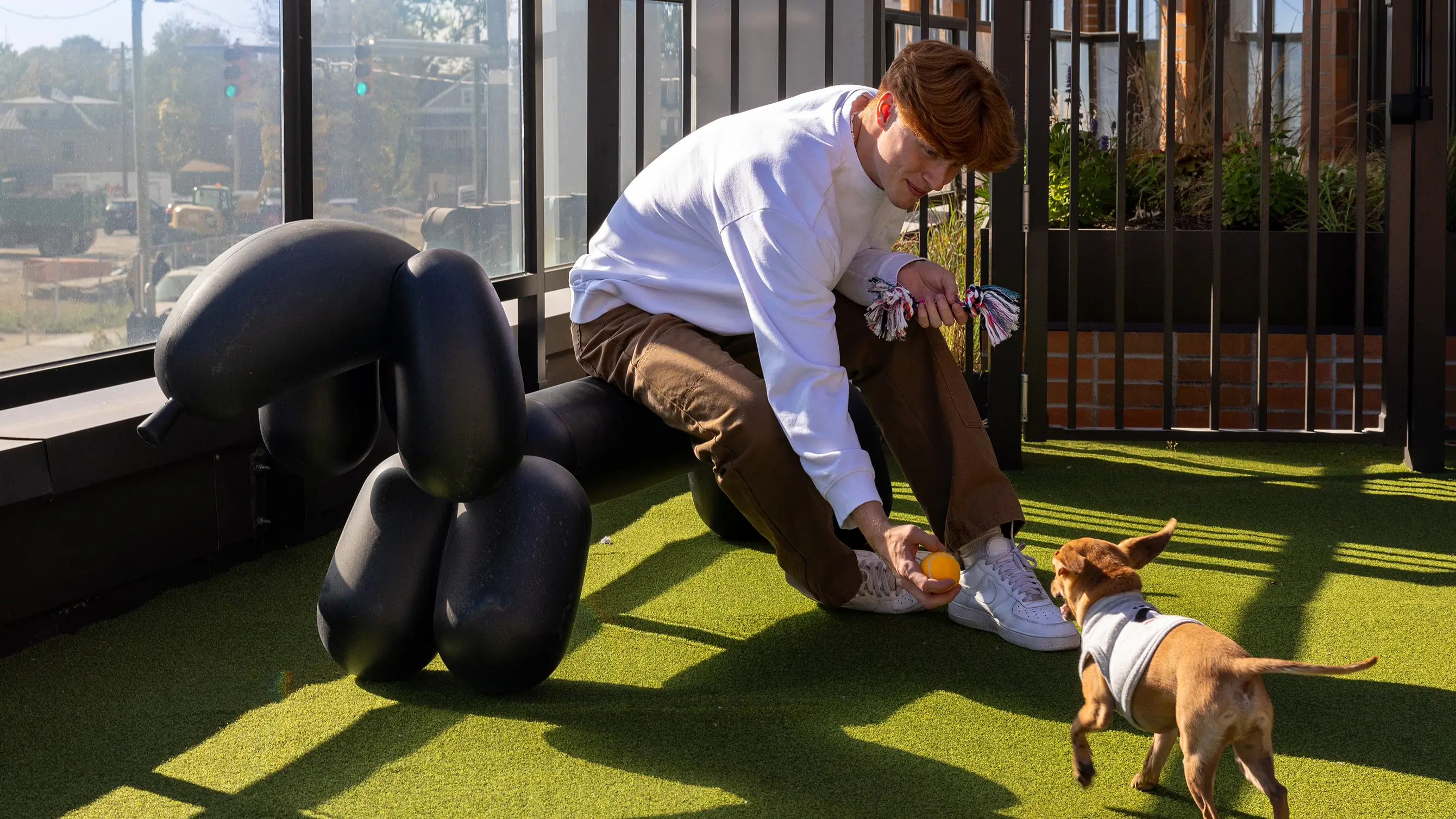 a man petting a small dog