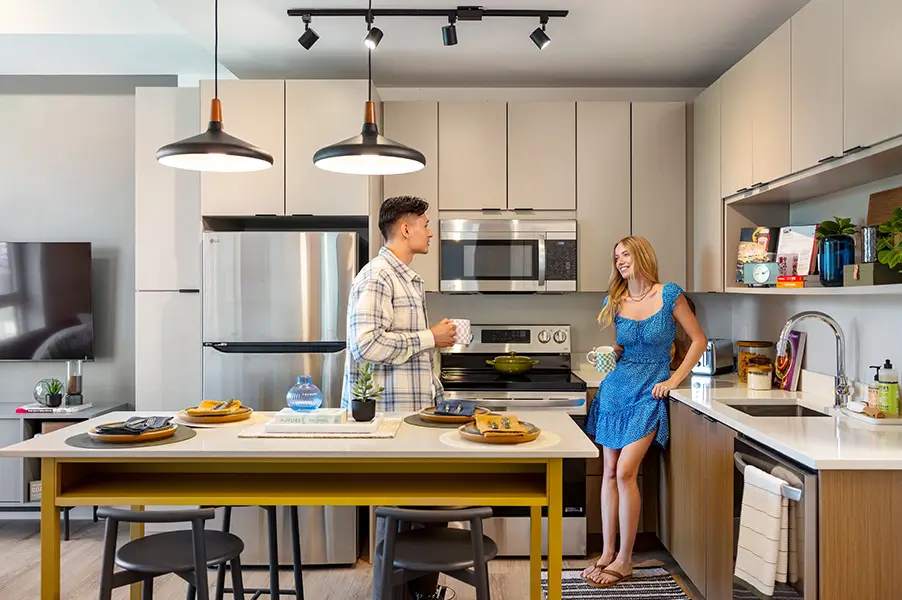 Two people talking in a kitchen