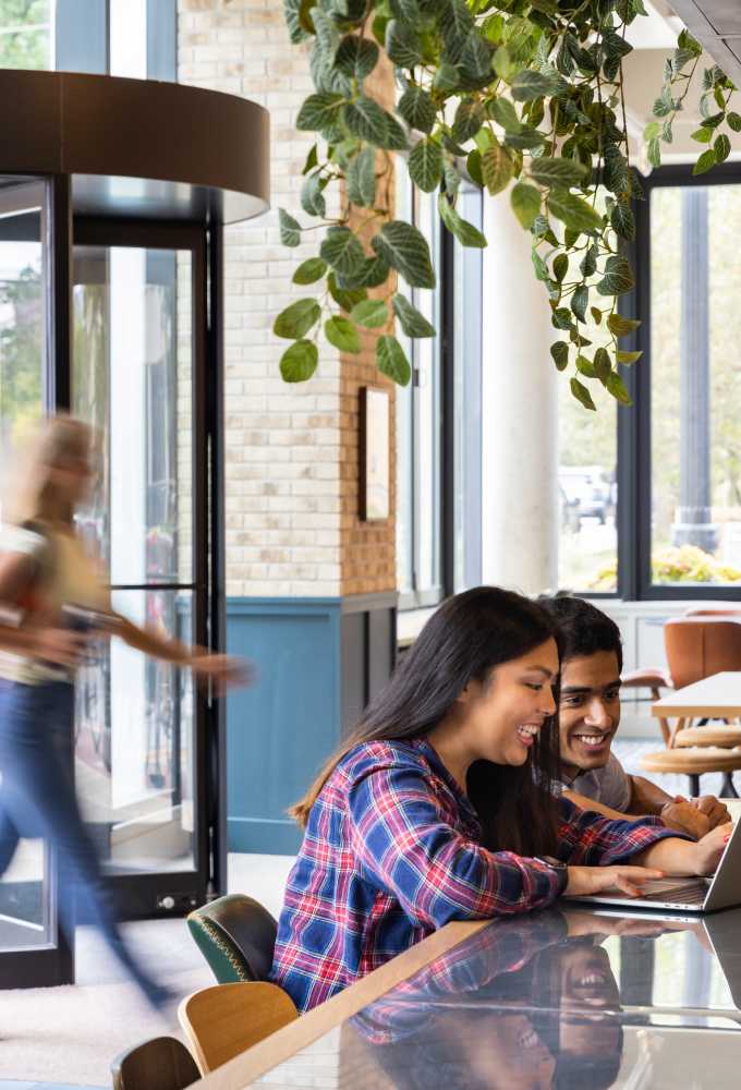 two friends hanging out on a computer