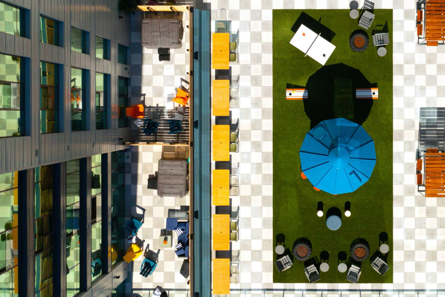 Overhead view of lawn with chairs and tables and an umbrella.