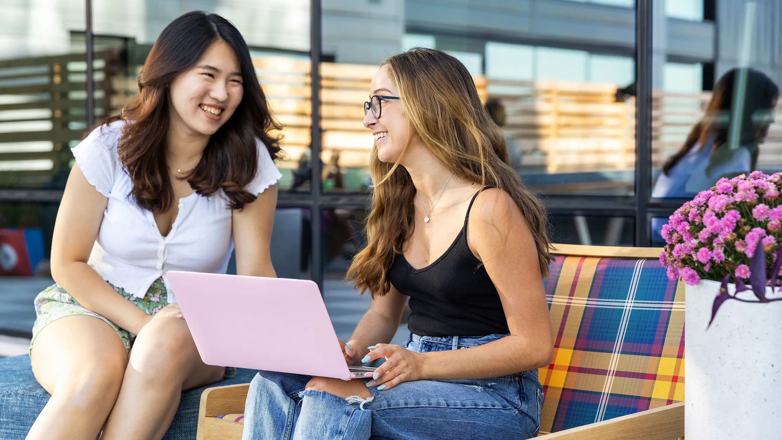 two women using a laptop