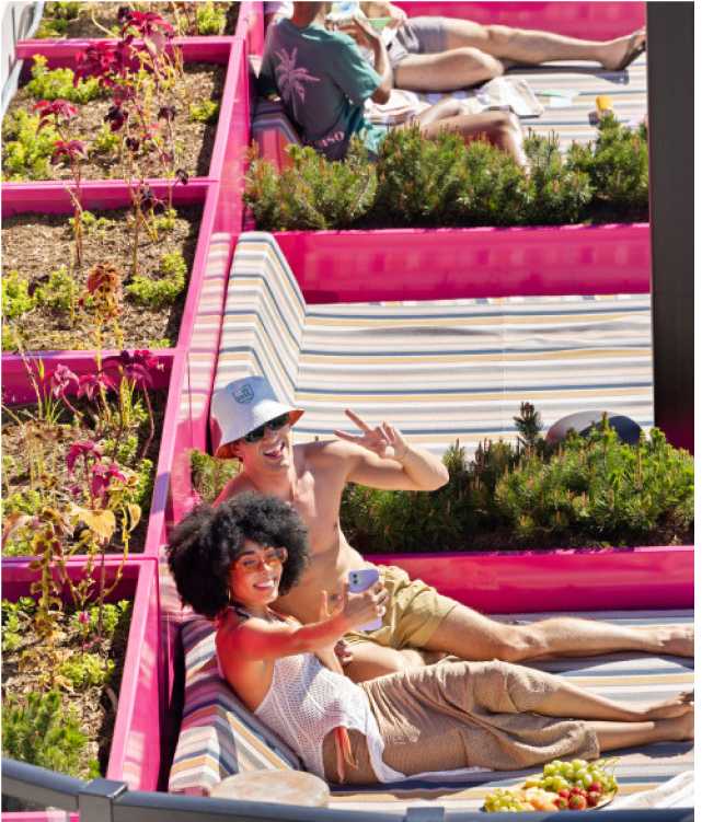 two people taking selfies in lounge chairs