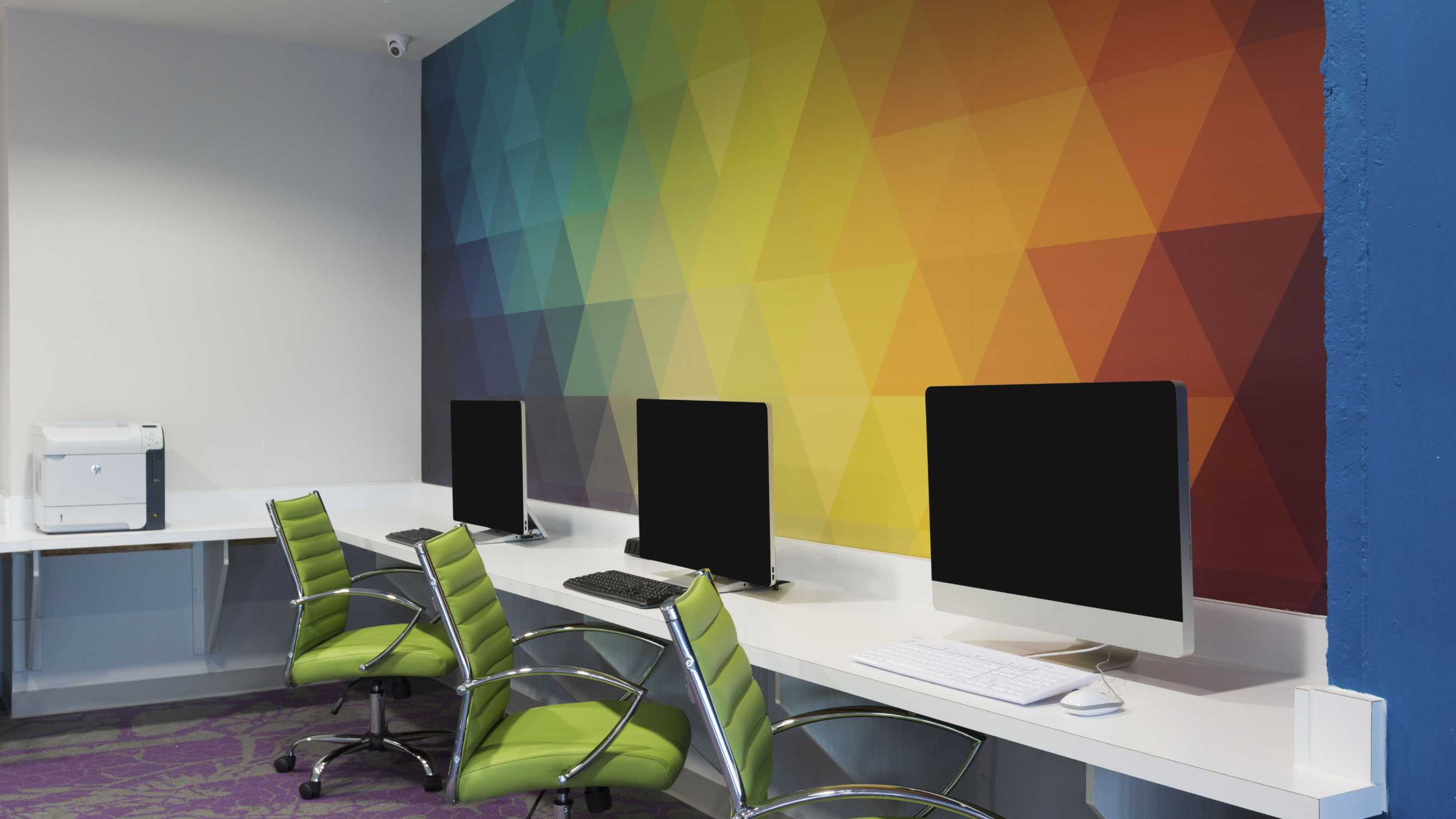 Rainbow mural next to computers in a study room