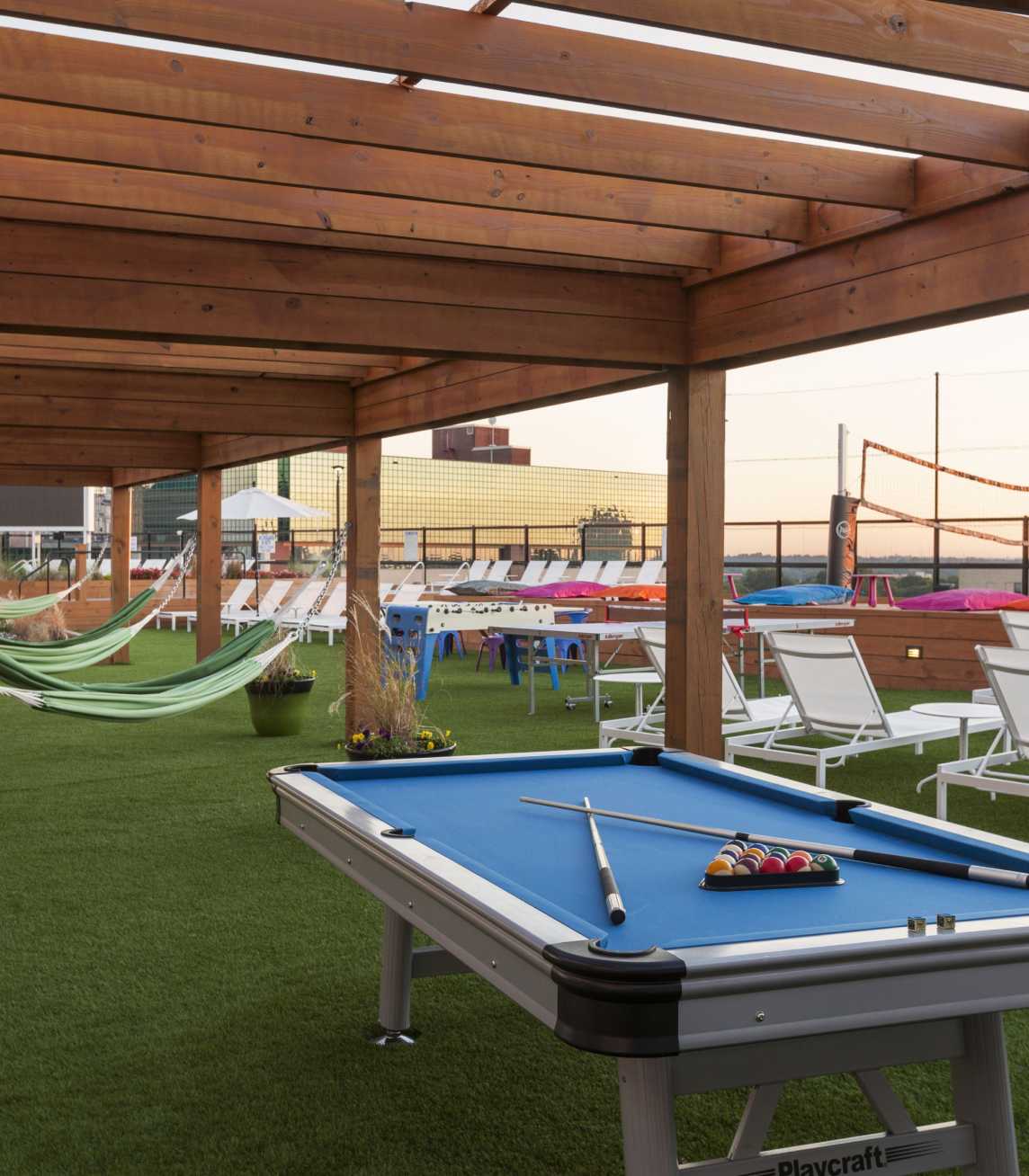 Outdoor pool table next to hammocks