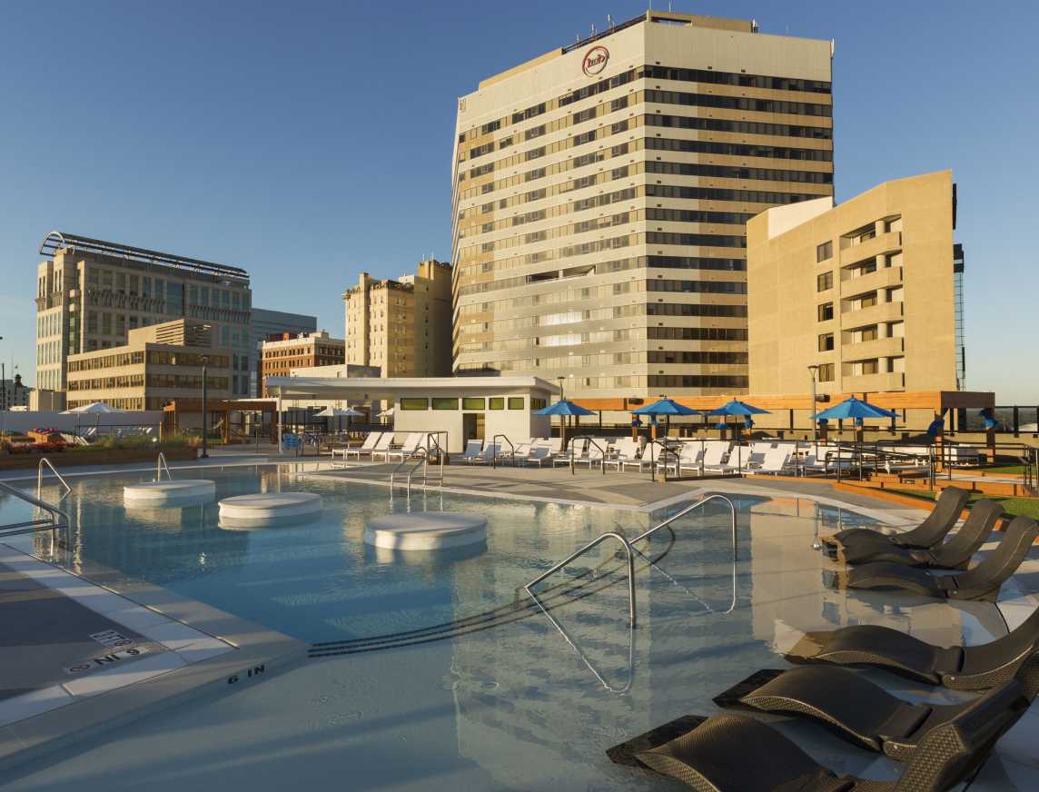 A sparkling resort-style swimming pool with a city view