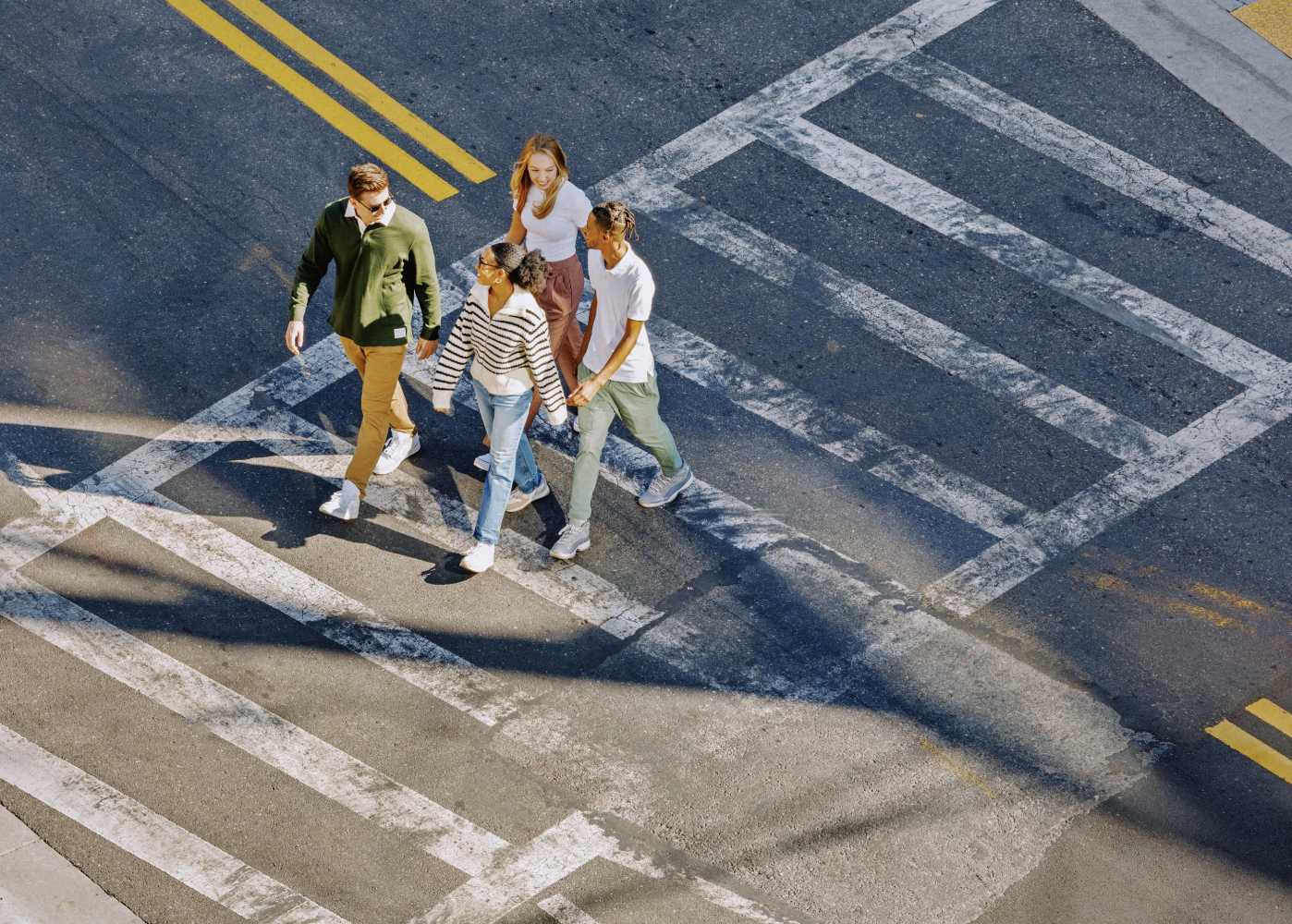 Four friends crossing a street