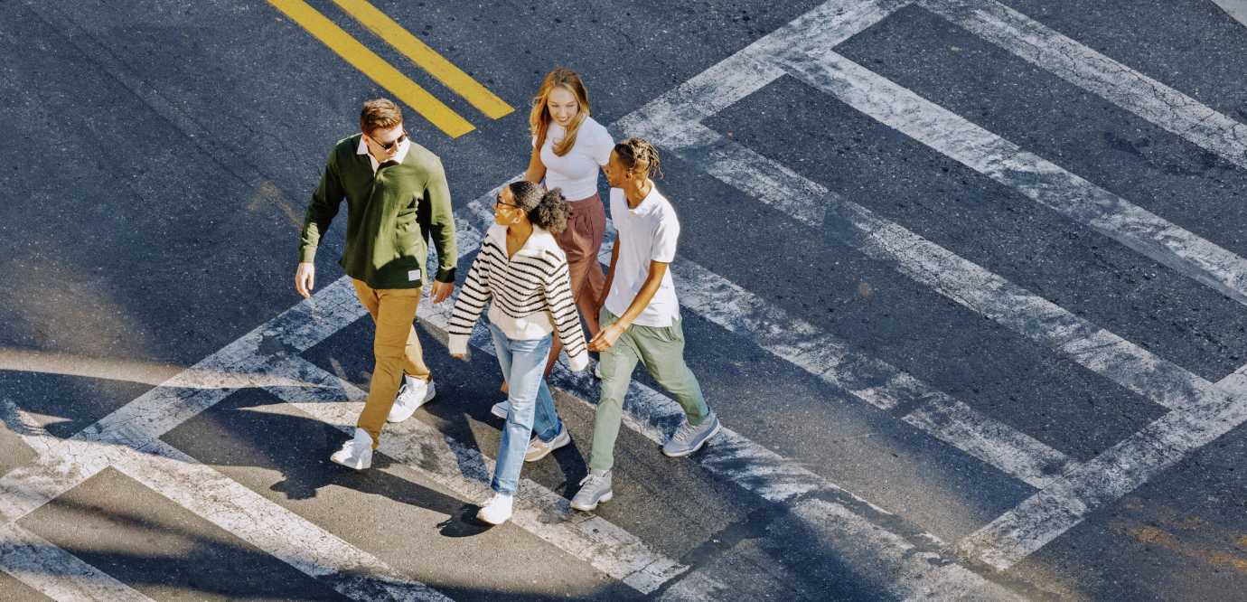 Group of friends crossing a road