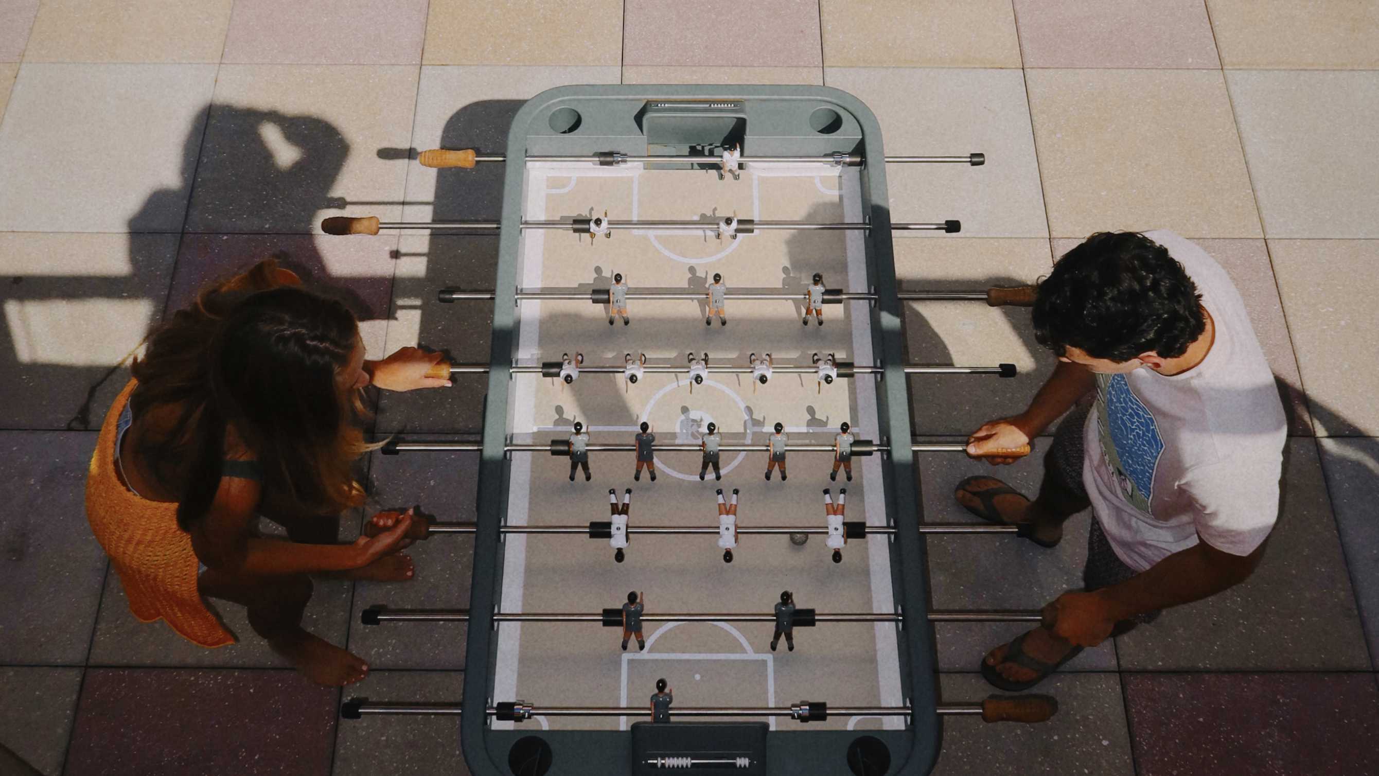 Group of friends playing foosball