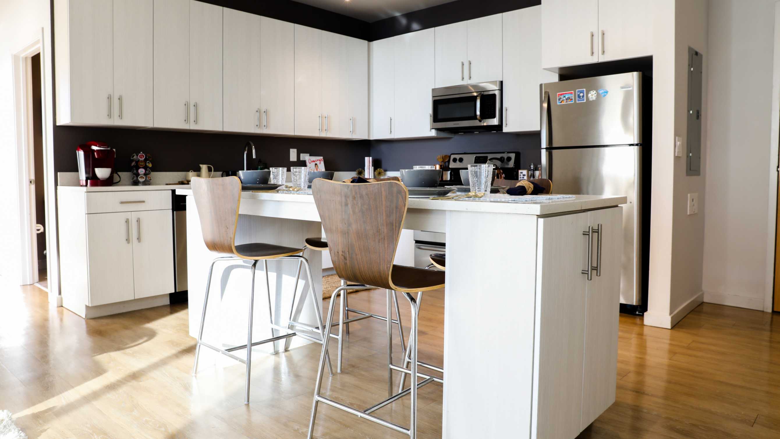 Kitchen with white cabinetry and stainless steel appliances