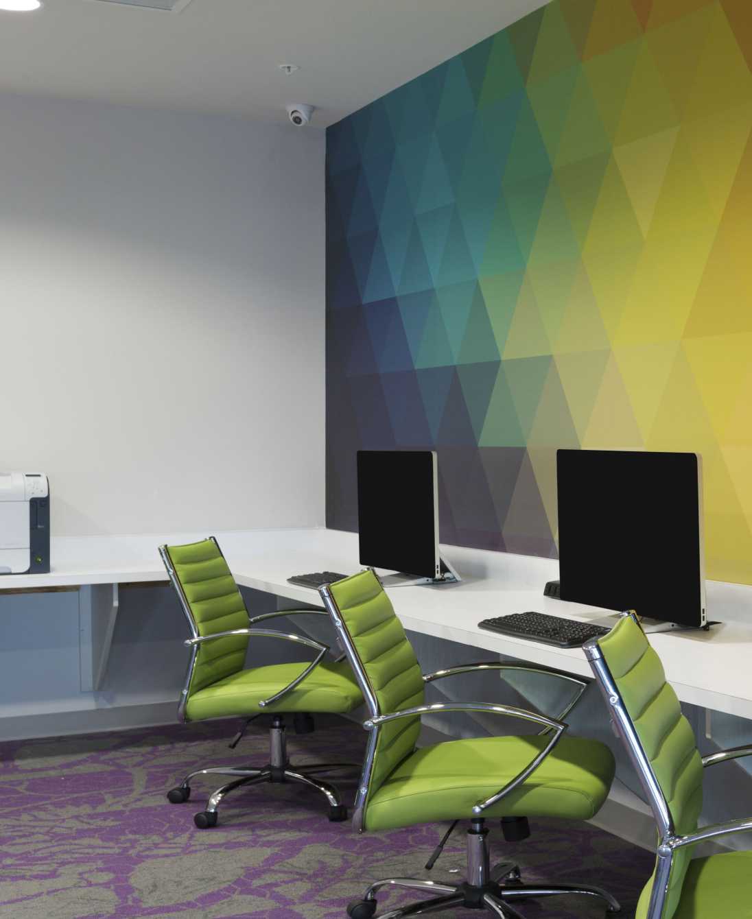 Study area with a colorful wall and desktop computers