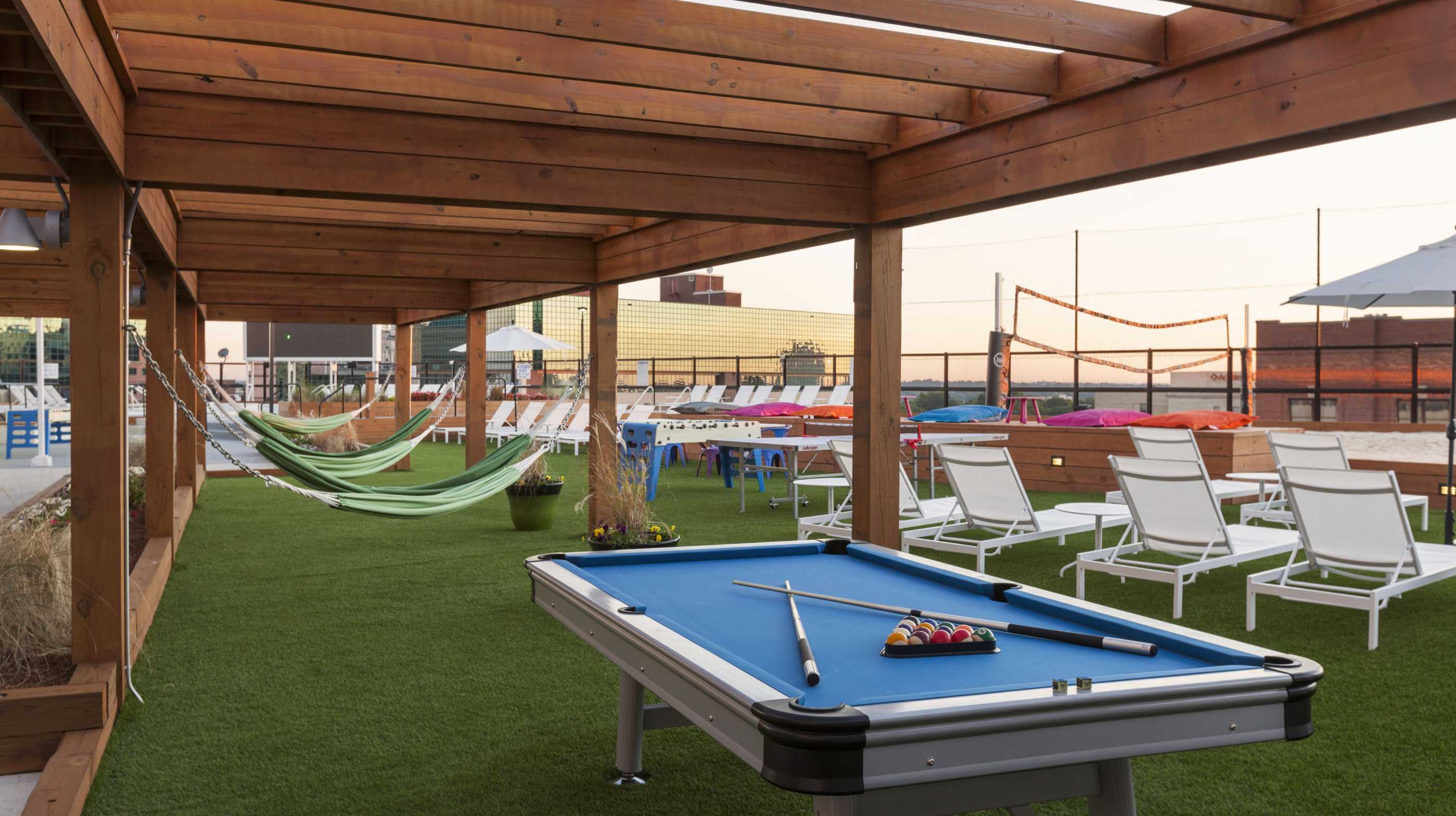 Outdoor pool table under a wooden awning