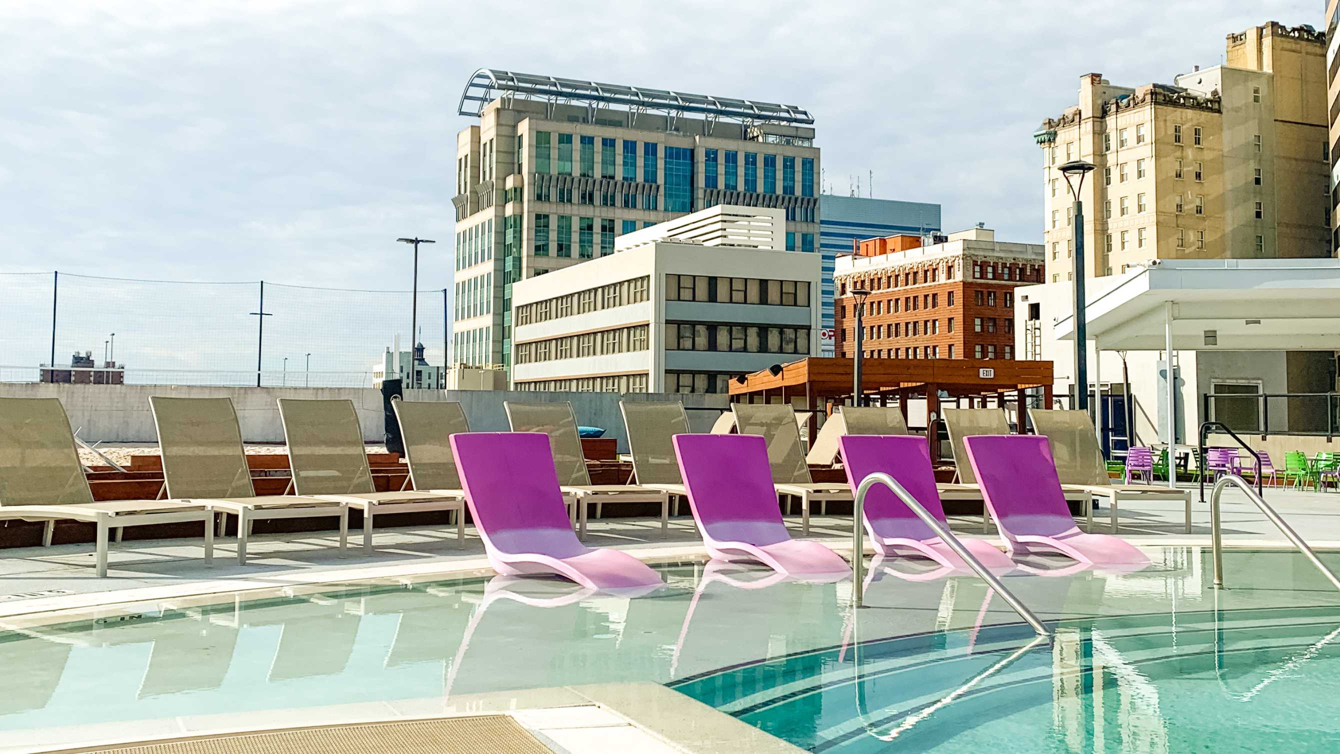 Pink chairs near a swimming pool