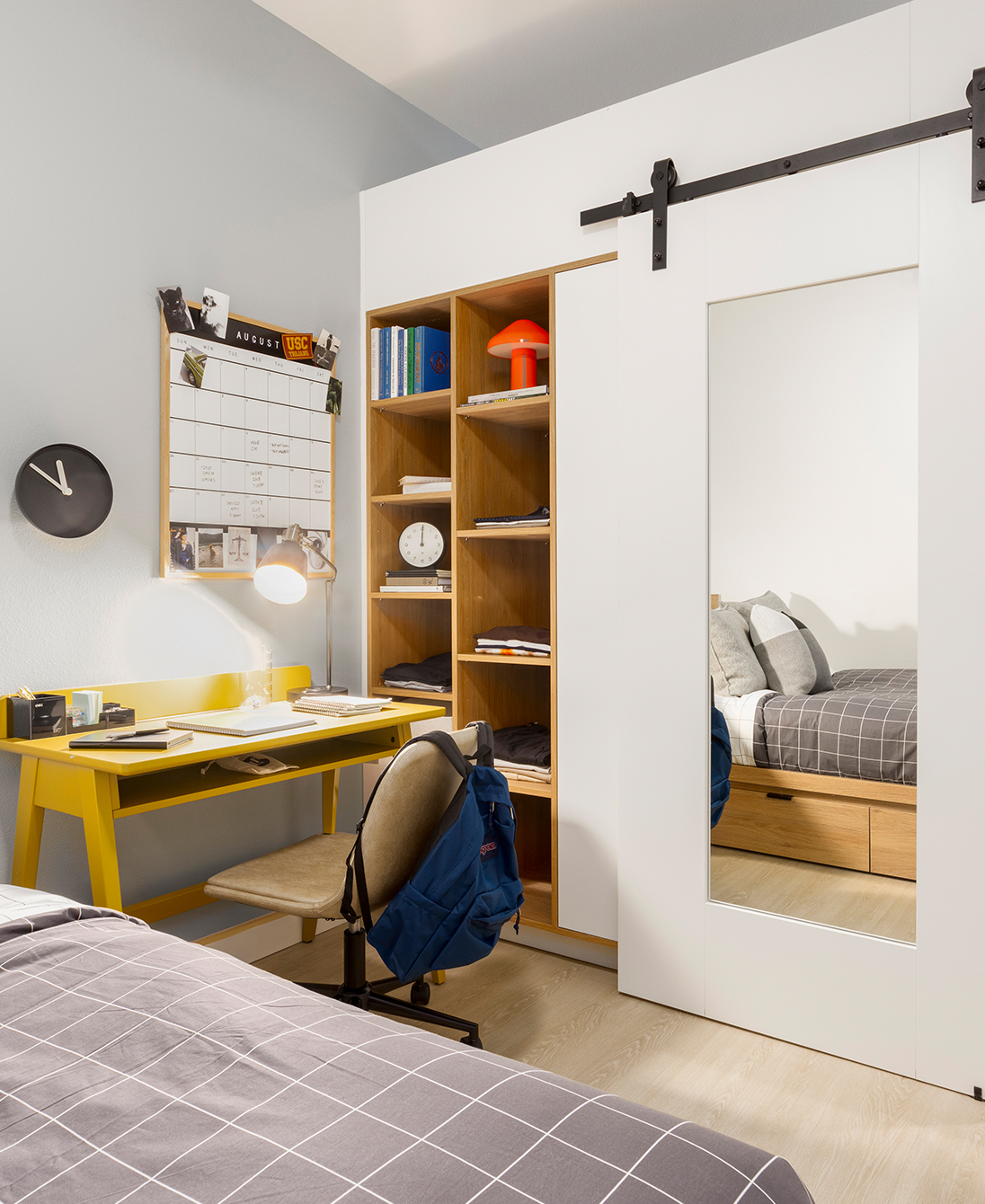 A bedroom with a study desk