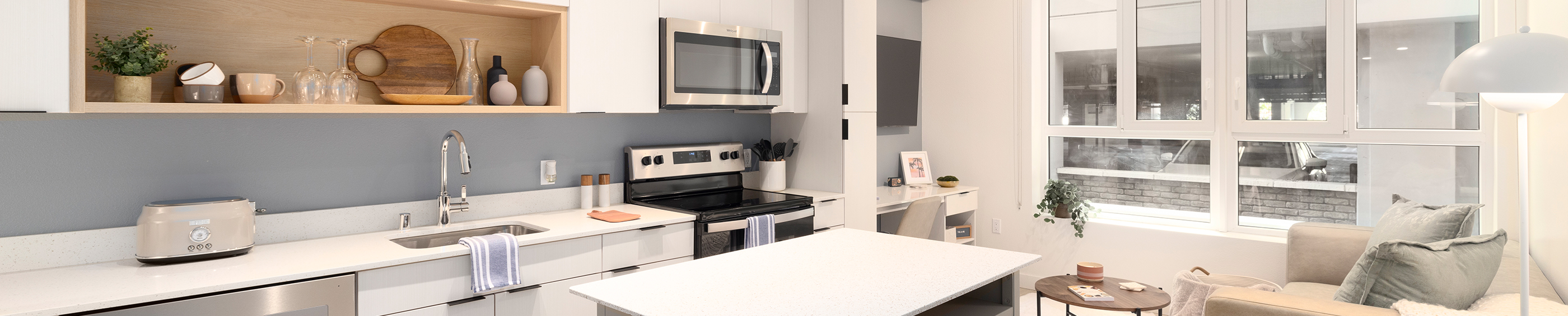 A kitchen with white cabinets and modern appliances