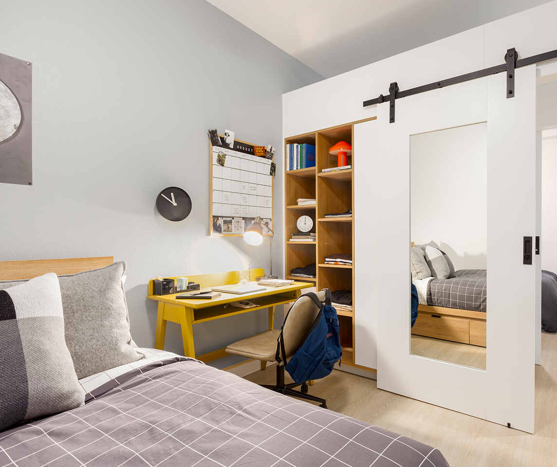 A bedroom with a study desk