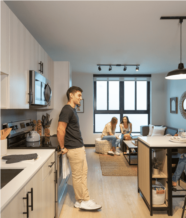 Man standing in a kitchen with white cabinets