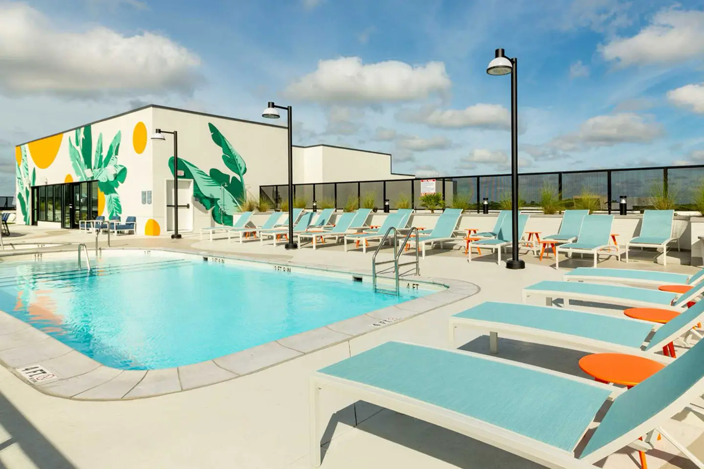 Rooftop pool with lounge seating and ligthing.