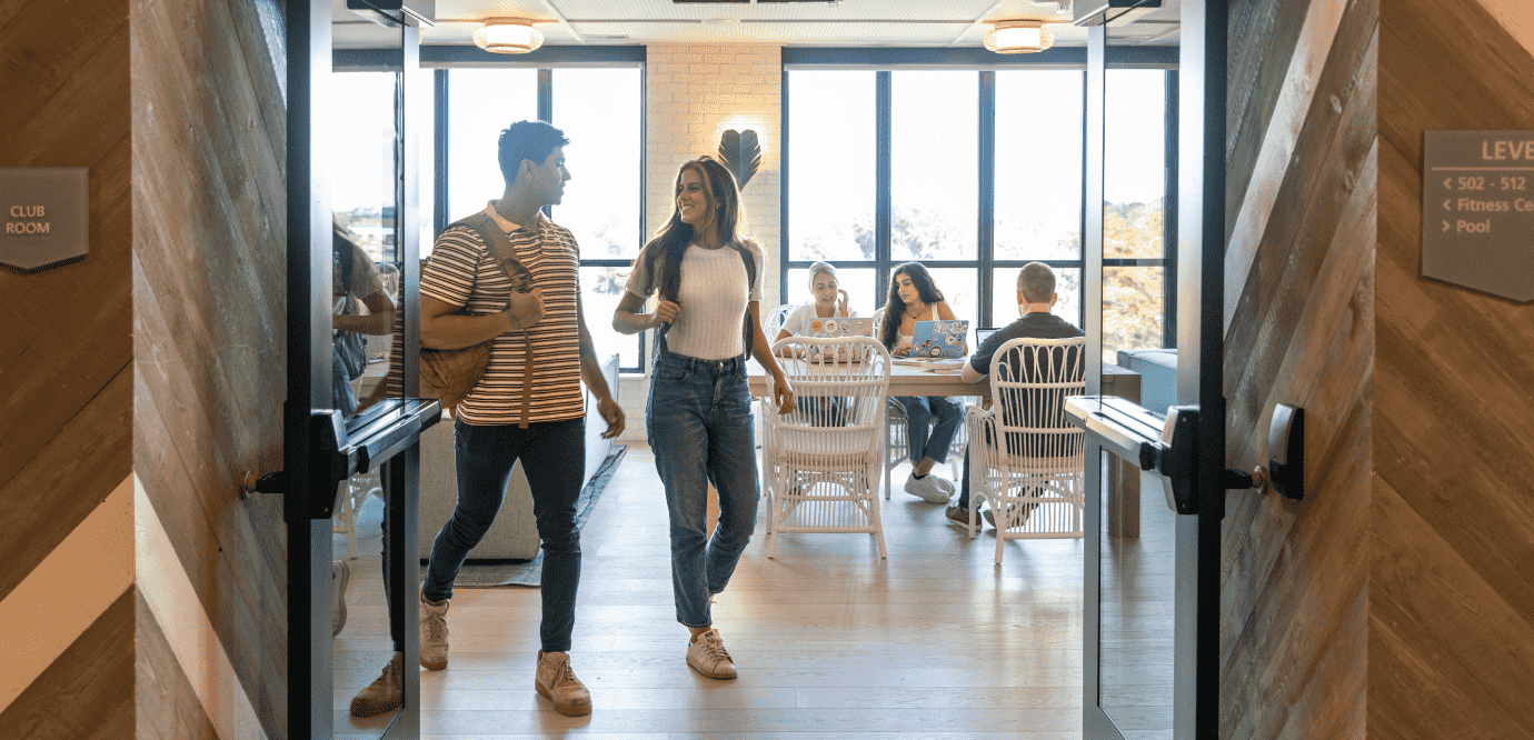 people walking though club room