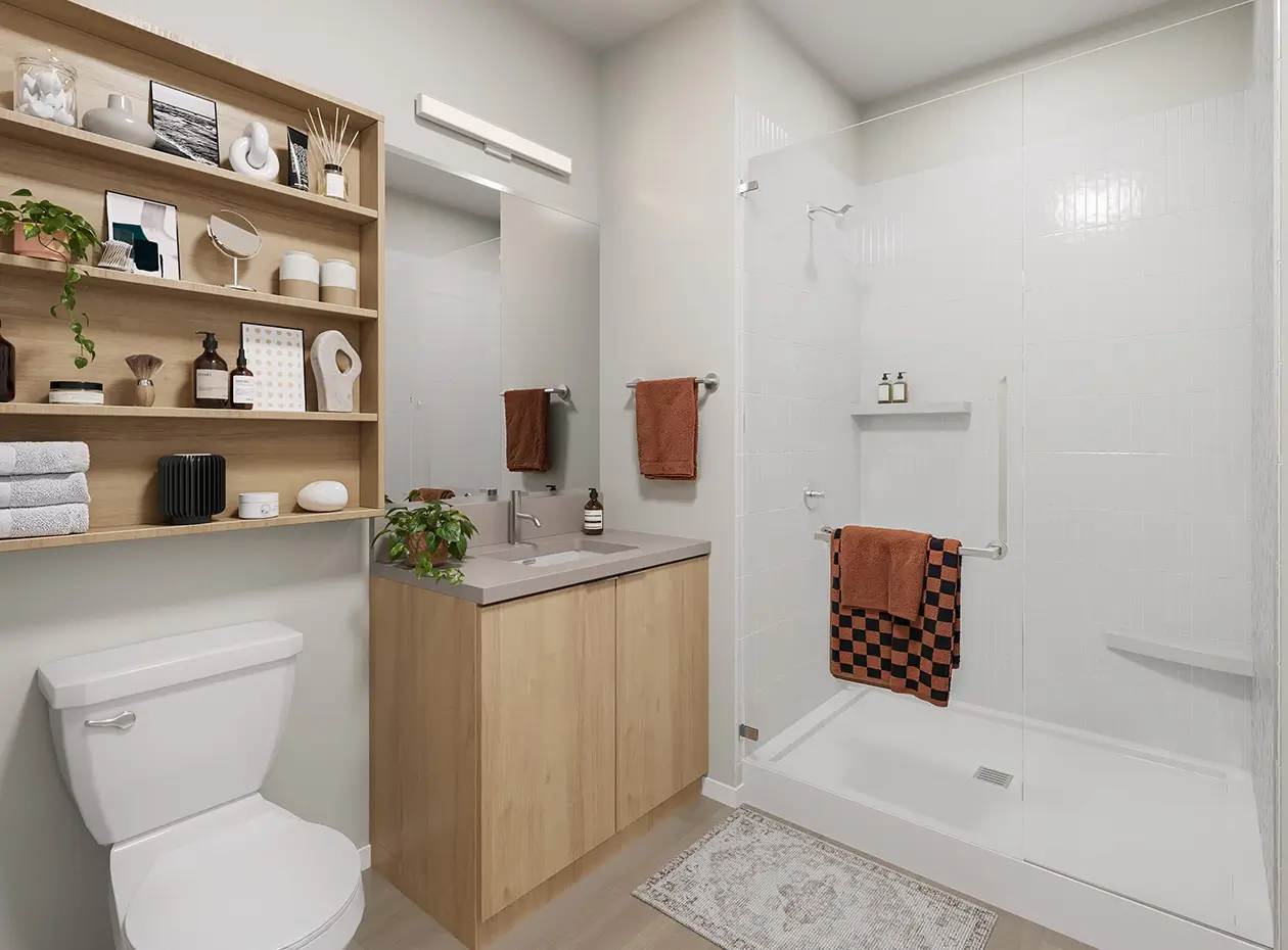Toilet, shower, and sink with cabinets.