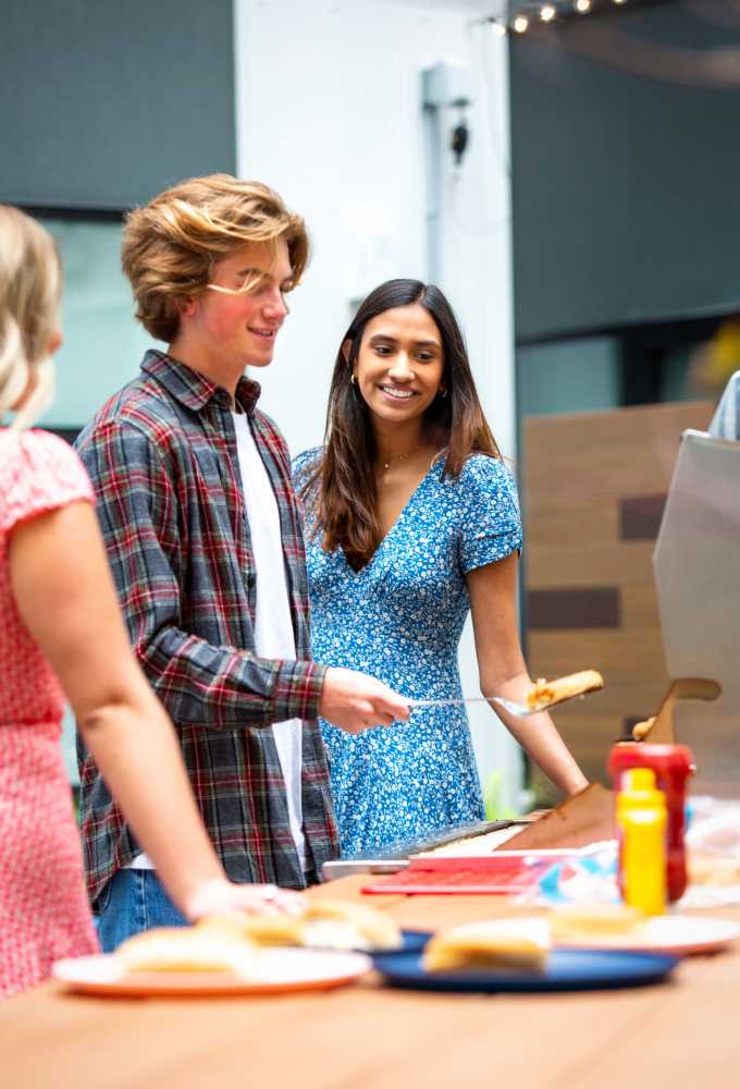 Friends serving food outside