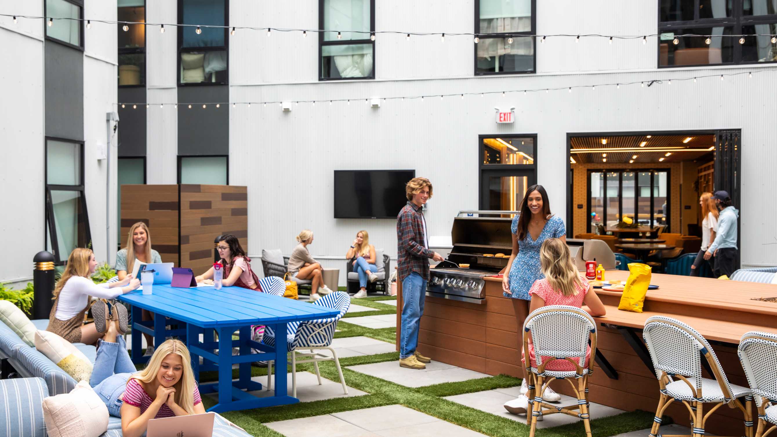 A group of people grilling and eating outside