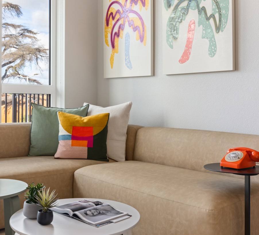 A living room with colorful palm tree wall art