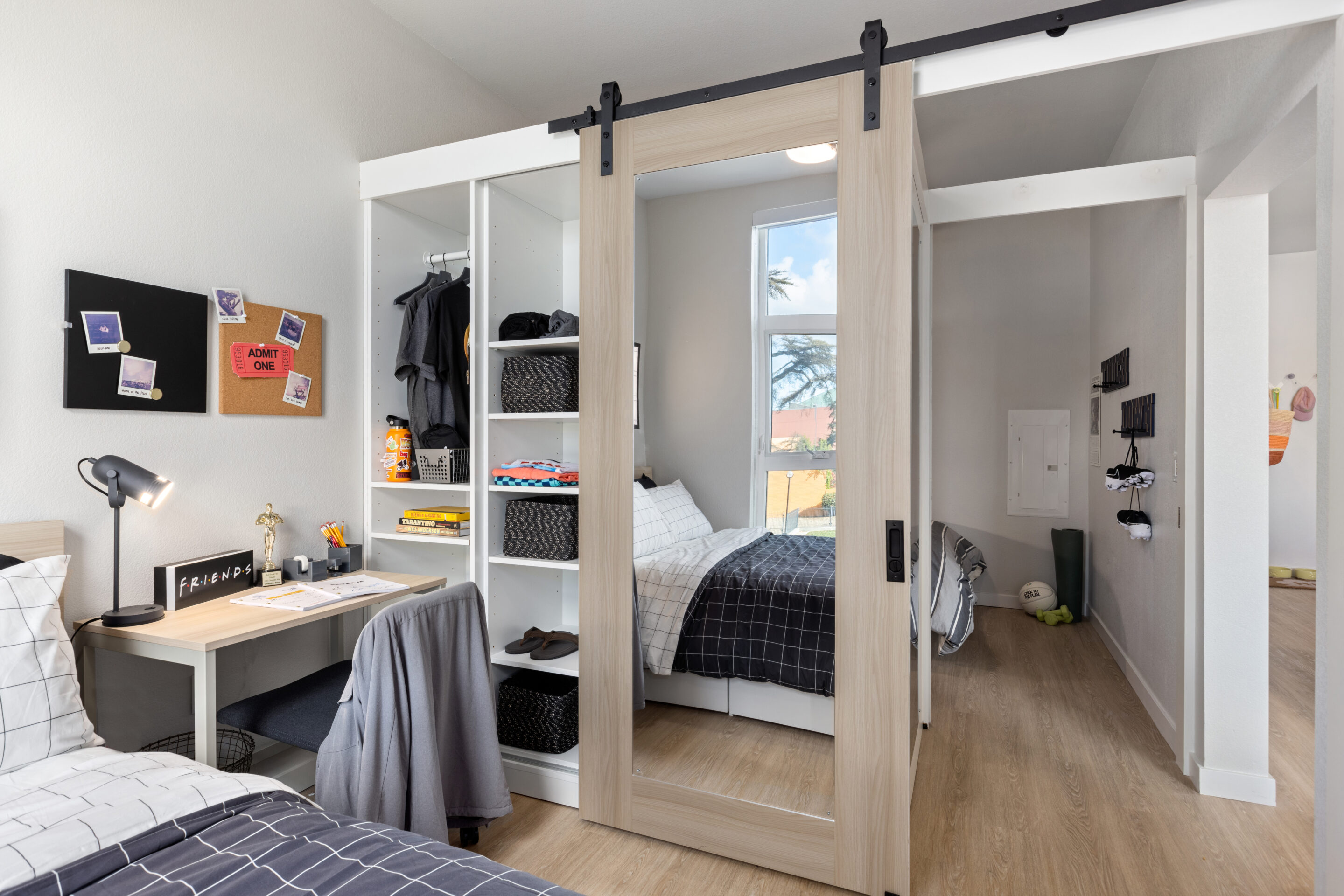 bedroom with a sliding mirror door, a closet, desk, and a bed.