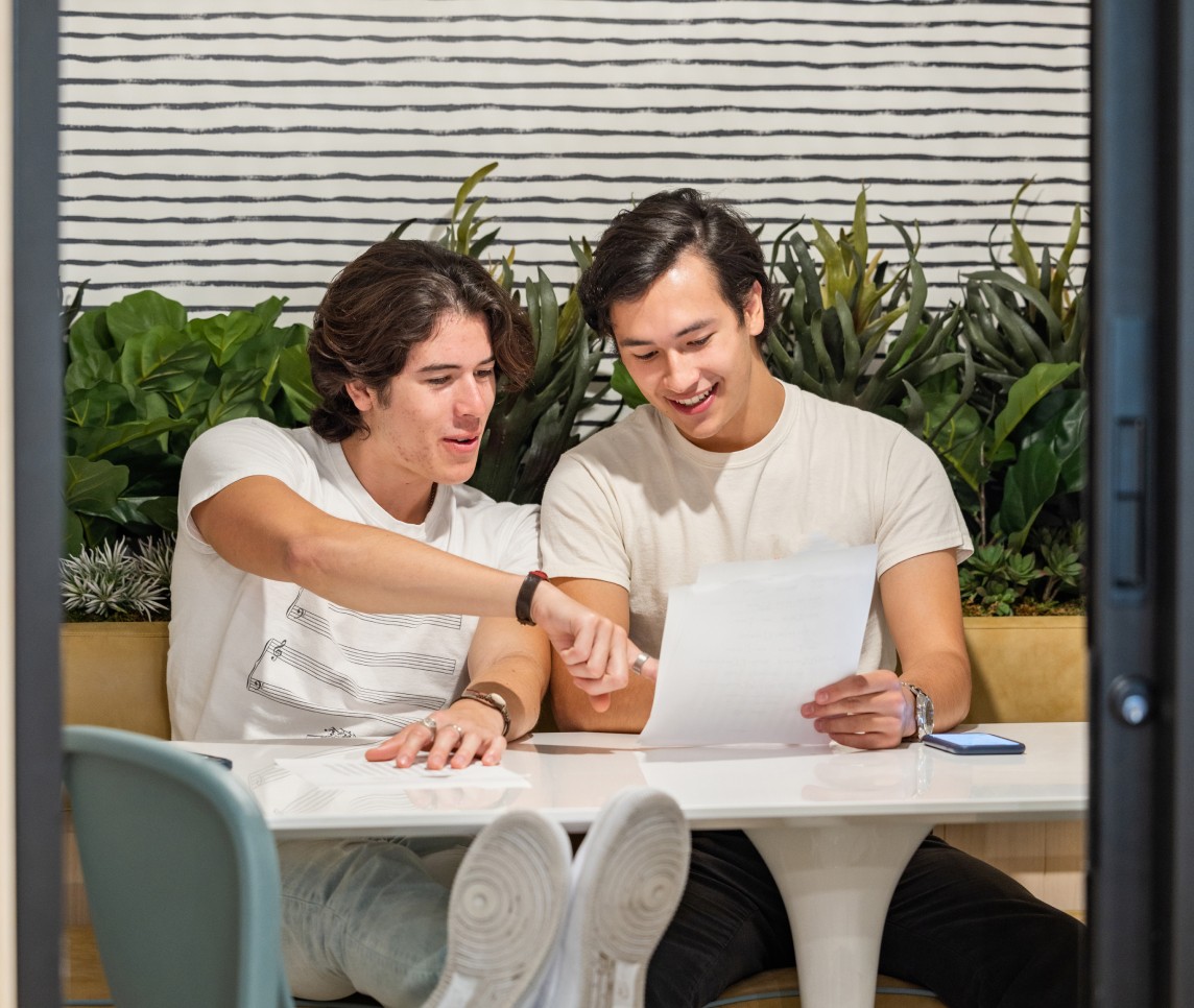 Two men looking at a piece of paper