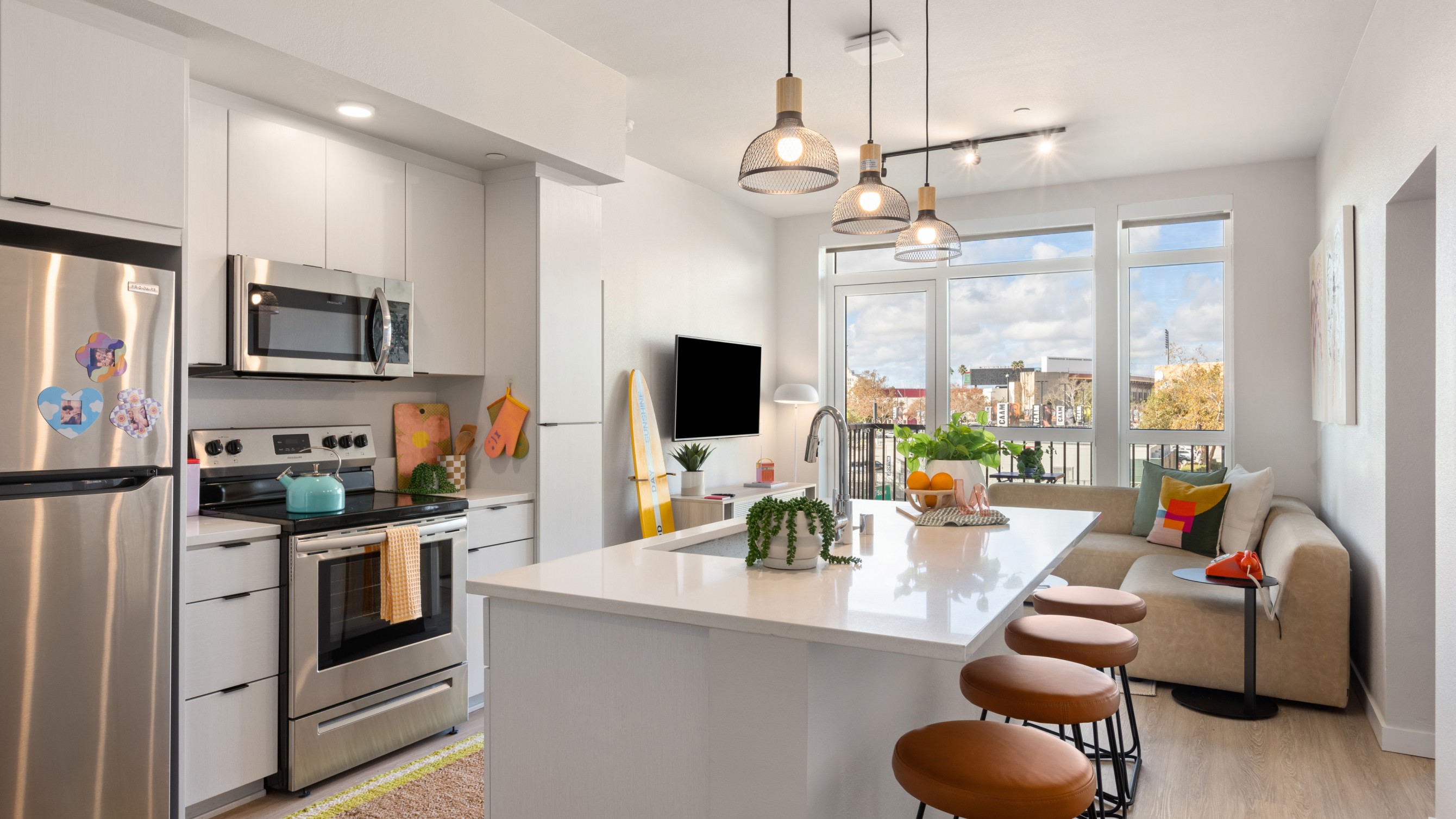 A kitchen with white cabinets and an island