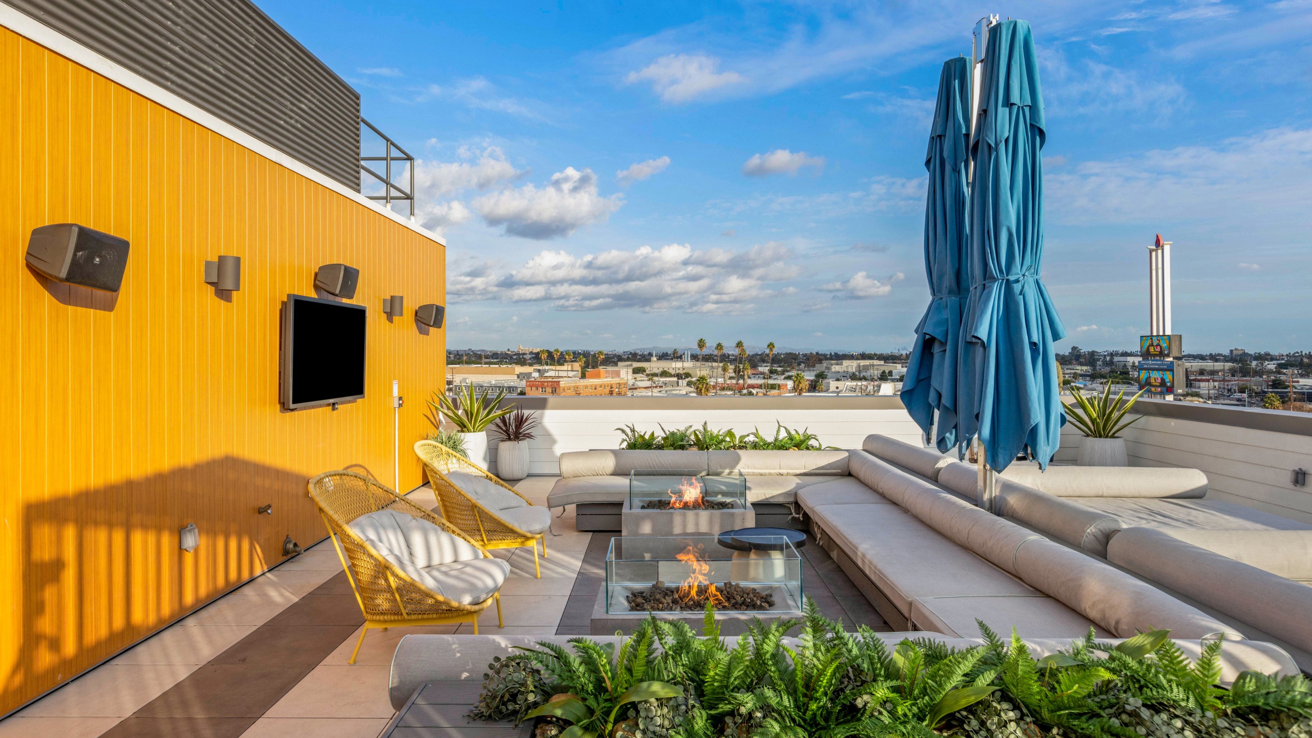 Blue umbrellas and outdoor firepits