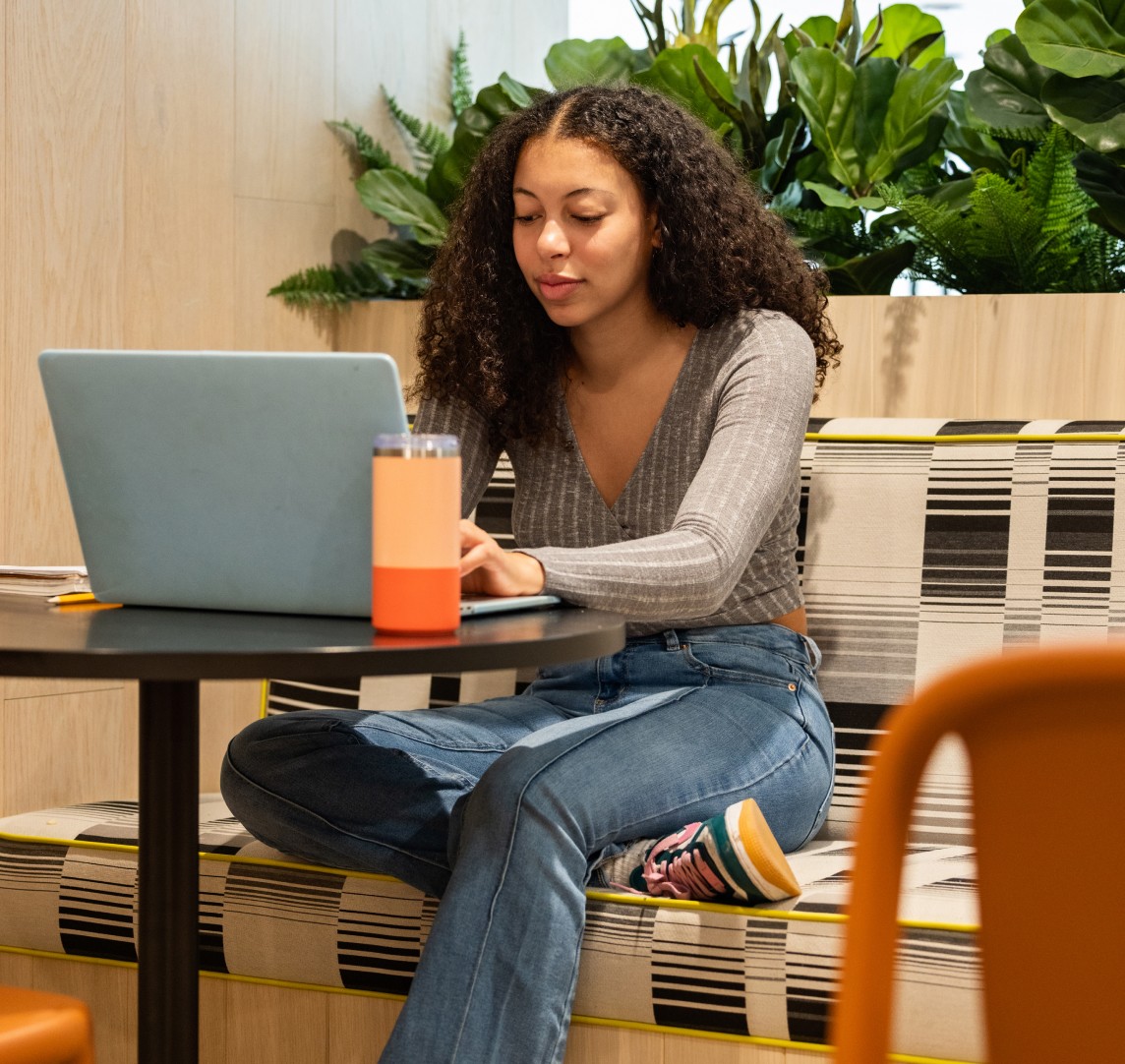 A woman typing on a laptop