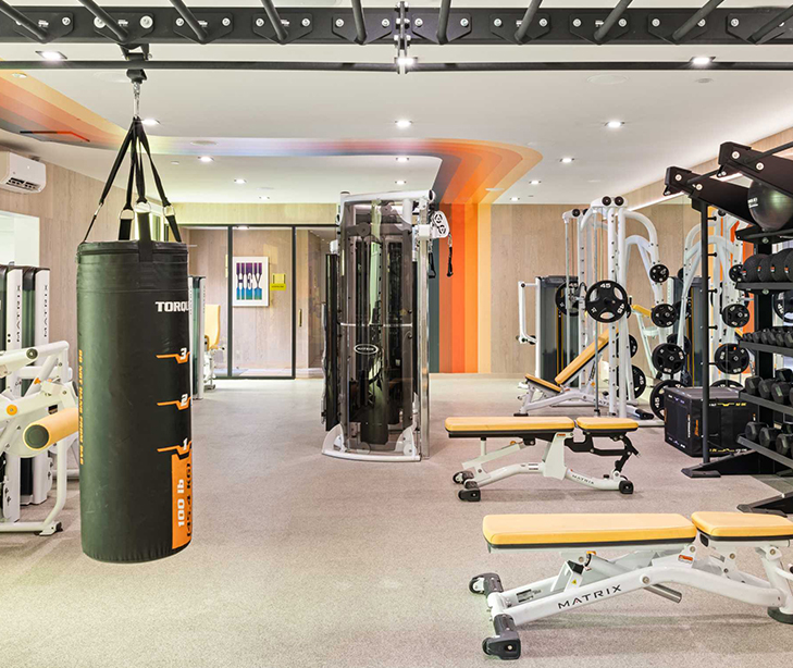 Gym with punching bags and weight benches.