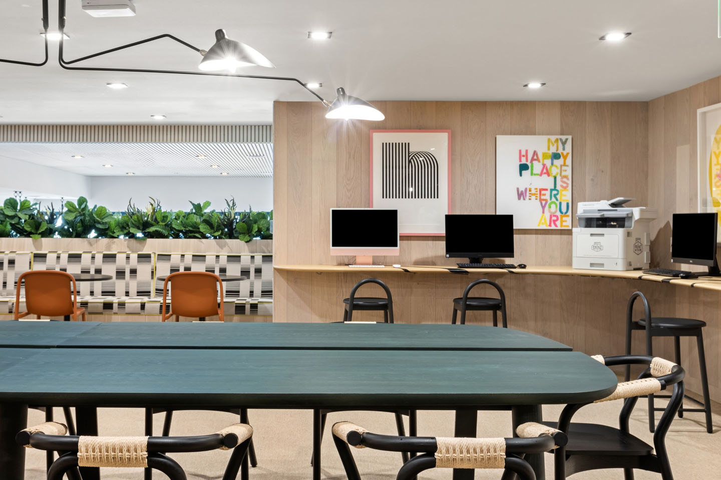 Resident lounge with group seating, a printer, and multiple desktop computers.