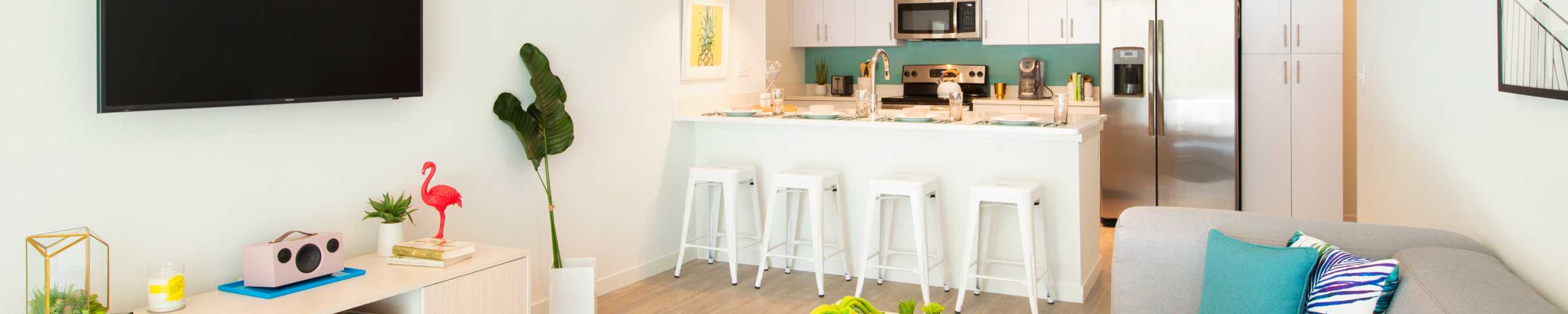 Kitchen with white bar stools