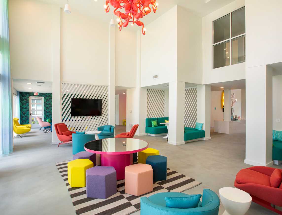 A lobby with rainbow seating and a TV