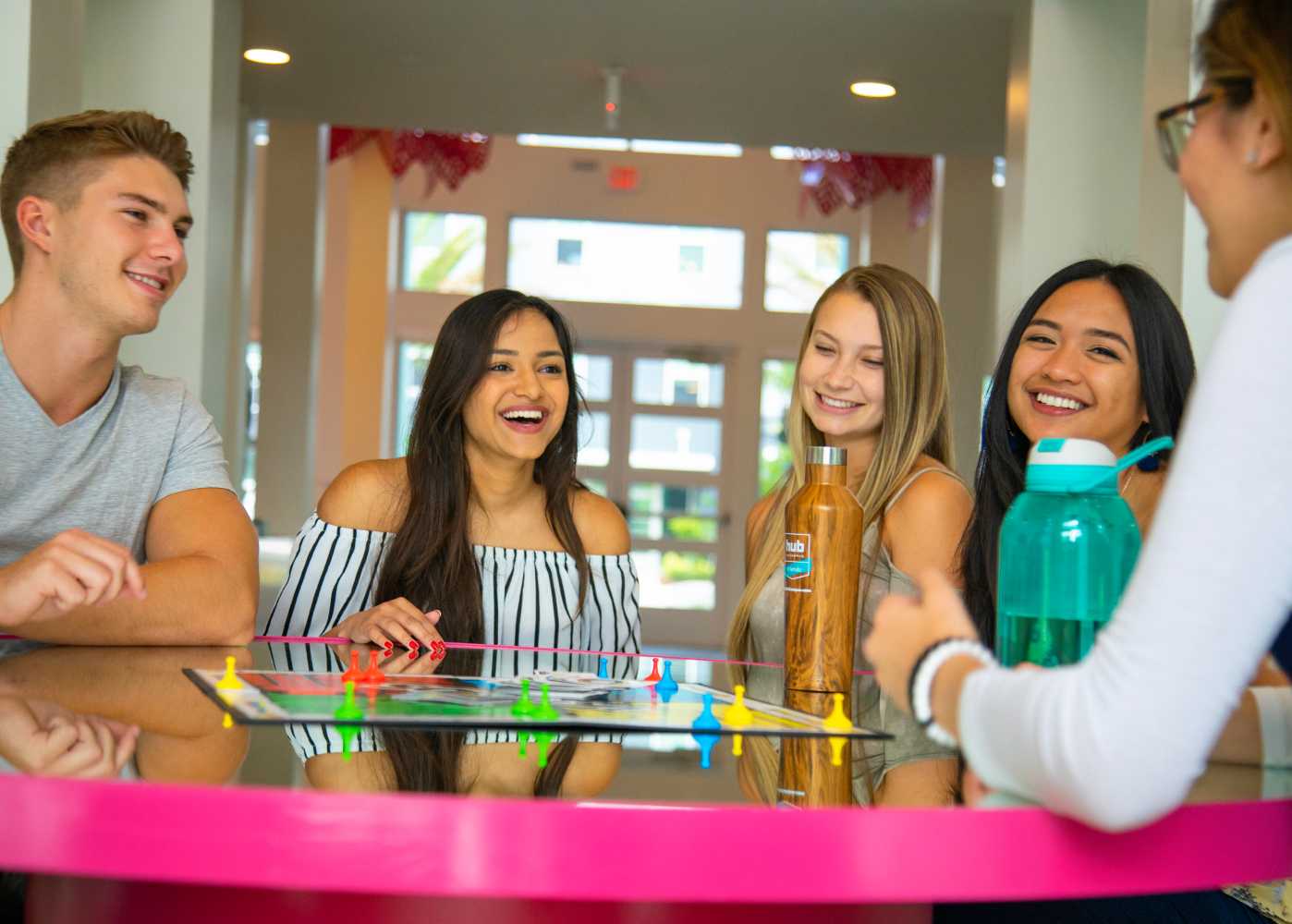 A group of friends sitting at a pink table