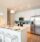 Kitchen with white bar stools and an island