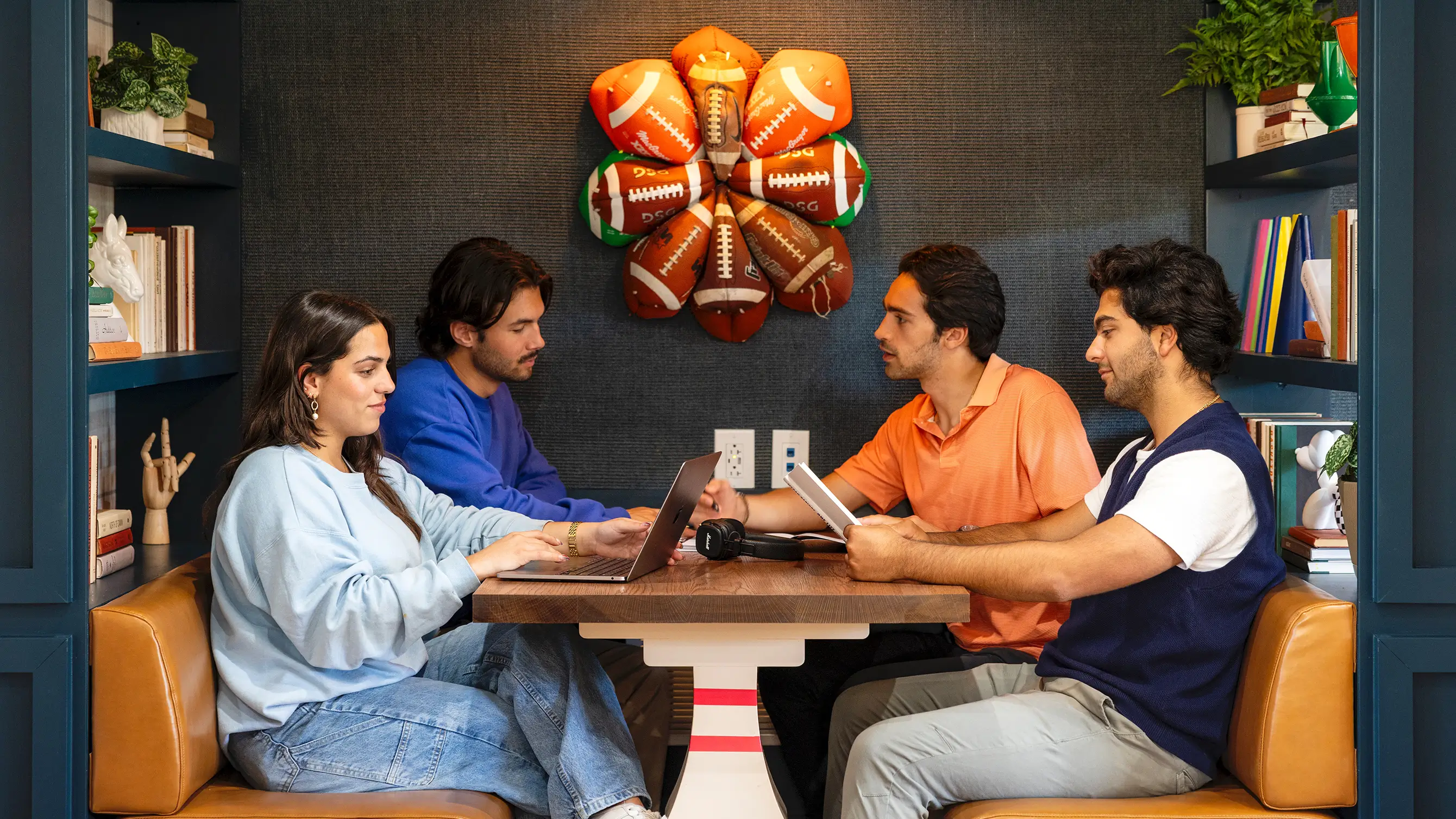 a group of friends studying using laptops