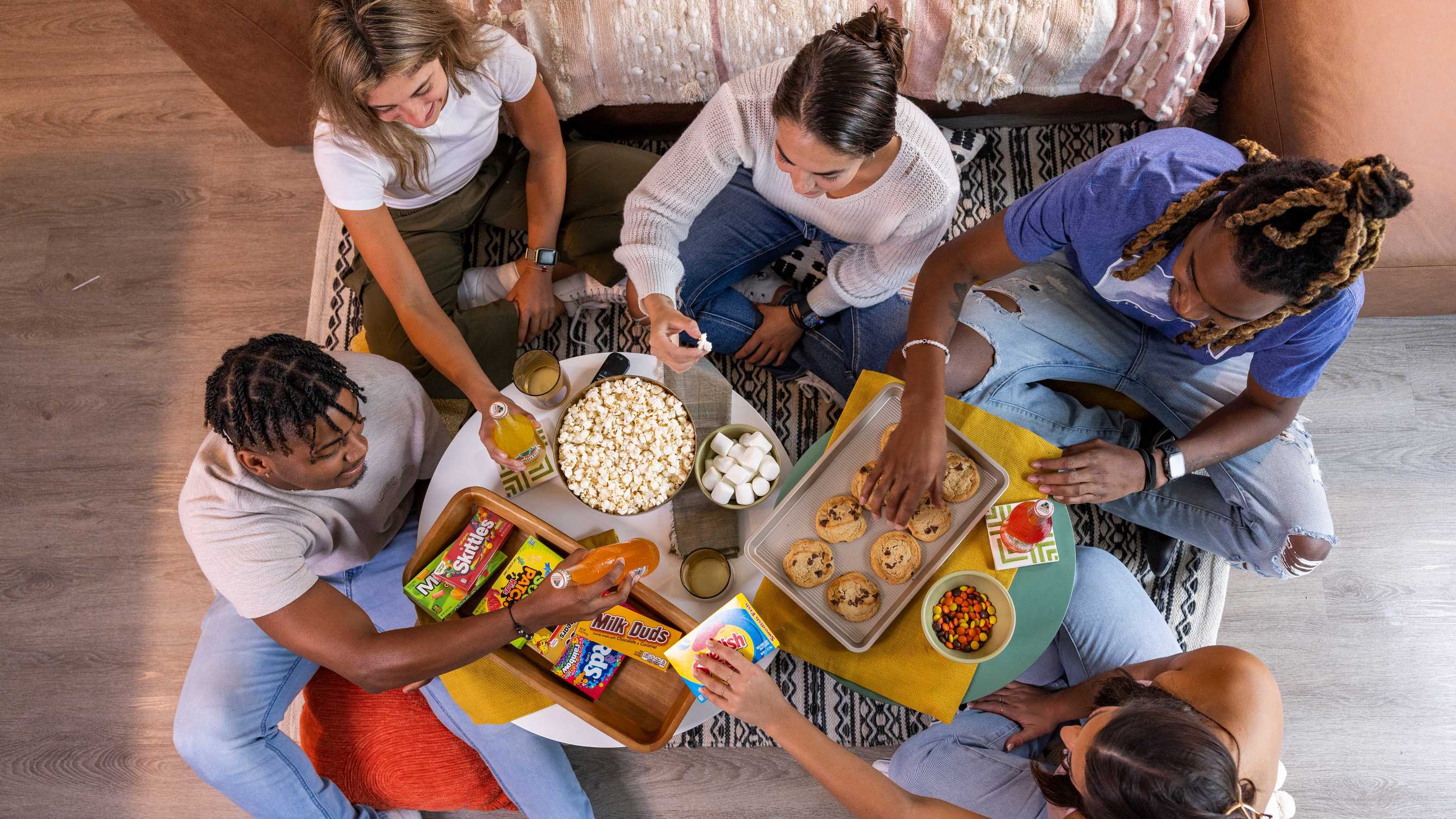 A group of friends eating snacks in an apartment