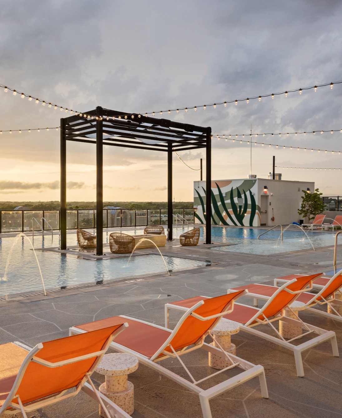 A swimming pool with orange pool chairs