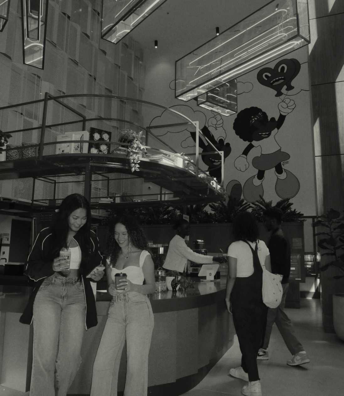 Friends holding coffee cups in a common area