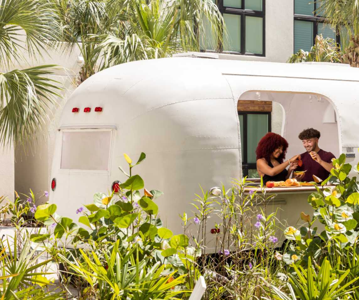 Two friends in a white trailer outside