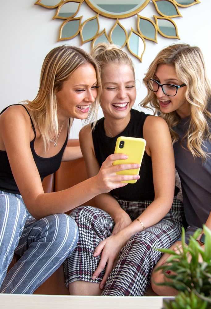 friends looking at a phone together