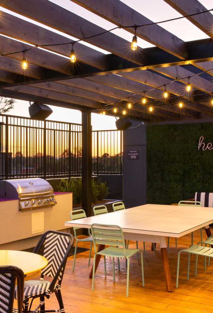 An outdoor wooden awning with string lights