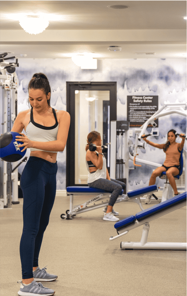 Three people working out in a gym